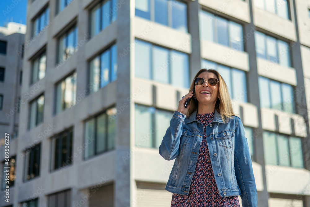 Young Businesswoman With Positive Emotion And Professional Look Smiling Confident In The City Using Cell Phone