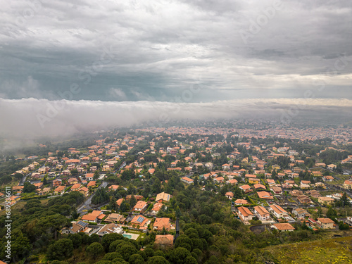 Nicolosi, Italy - Elevated View of Residential Area under a Dramatic Cloudscape photo