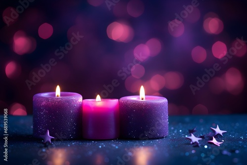 Burning candles with bokeh lights and stars on dark background.
