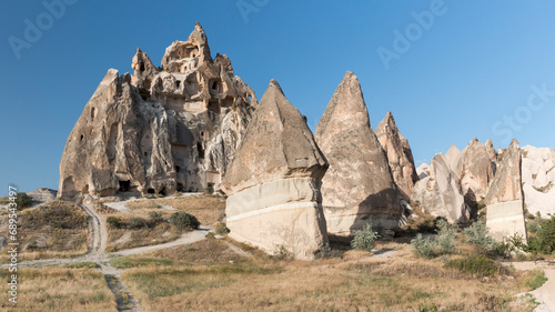 volcanic cliffs with carved dove houses and fairy chimneys in Rose Valley, Cappadocia, Turkey