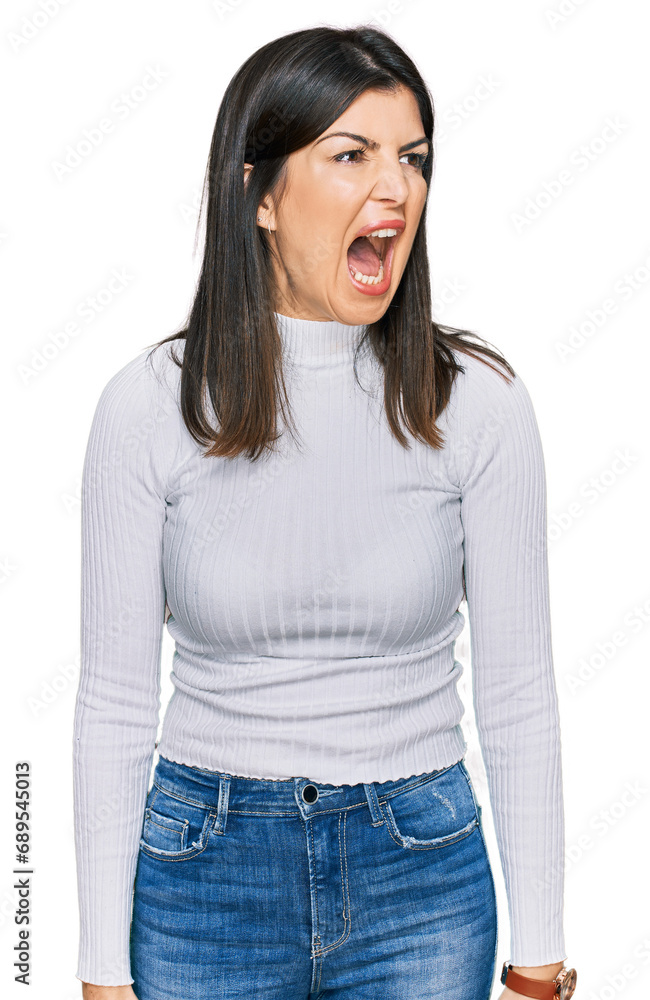 Beautiful brunette woman wearing casual clothes angry and mad screaming frustrated and furious, shouting with anger. rage and aggressive concept. Beautiful brunette woman wearing casual clothes angry and mad screaming frustrated and furious, shouting with anger. rage and aggressive concept.