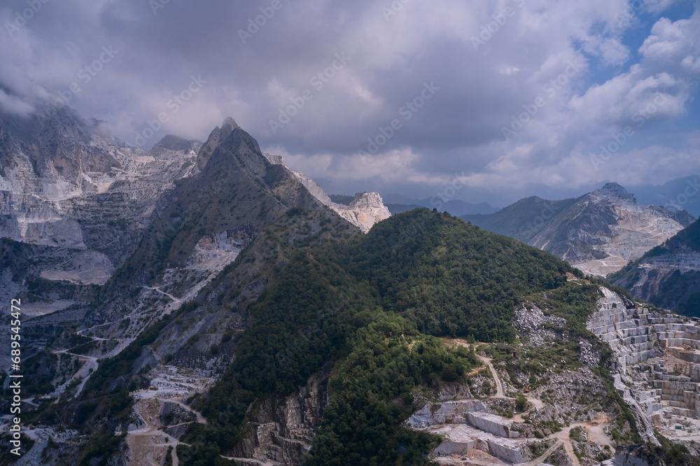 Aerial panorama of marble quarries Carrara Italy. Aerial panorama on the Carrara marble quarry. Marble quarry in the mountains at high altitude. Marble quarry top view.