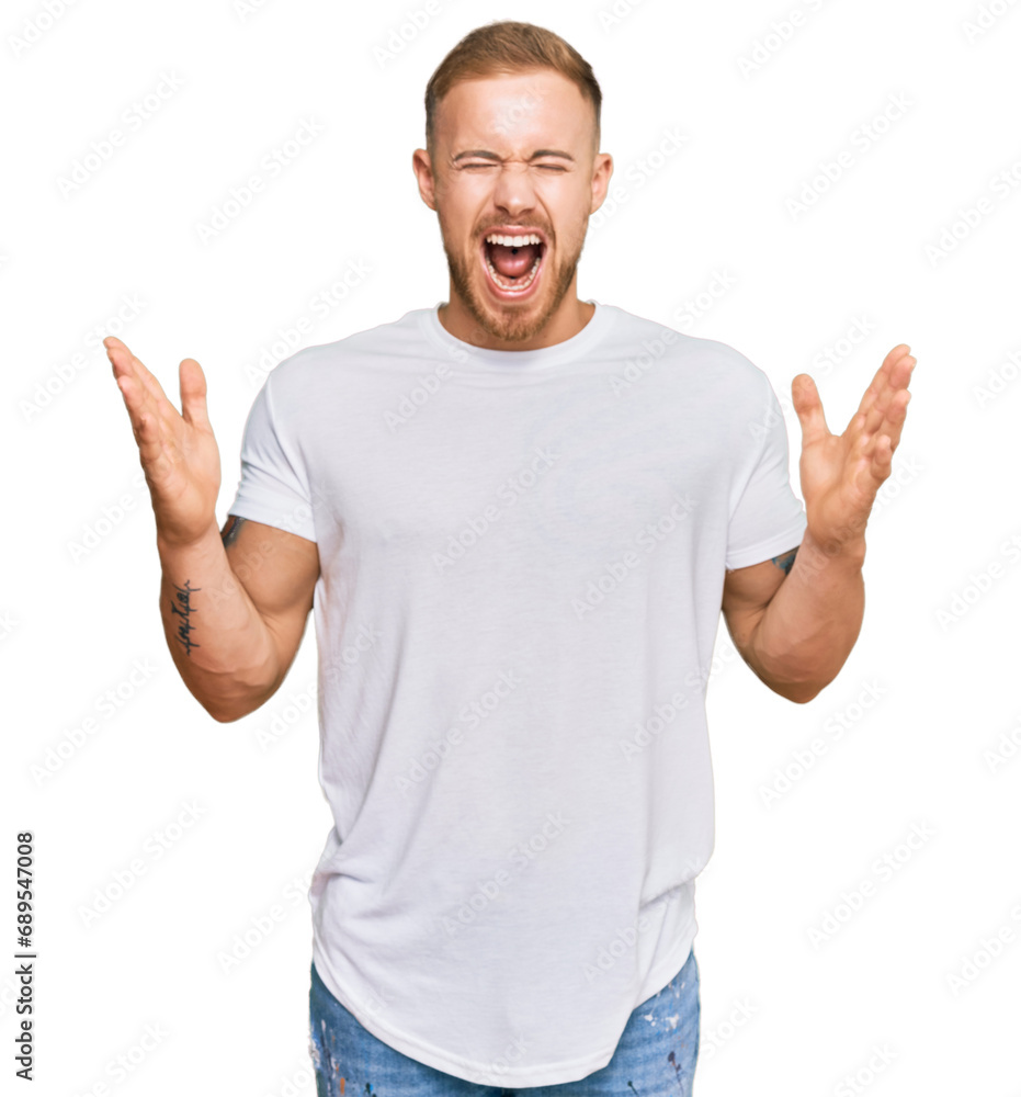 Young irish man wearing casual clothes celebrating mad and crazy for success with arms raised and closed eyes screaming excited. winner concept Young irish man wearing casual clothes celebrating mad and crazy for success with arms raised and closed eyes screaming excited. winner concept