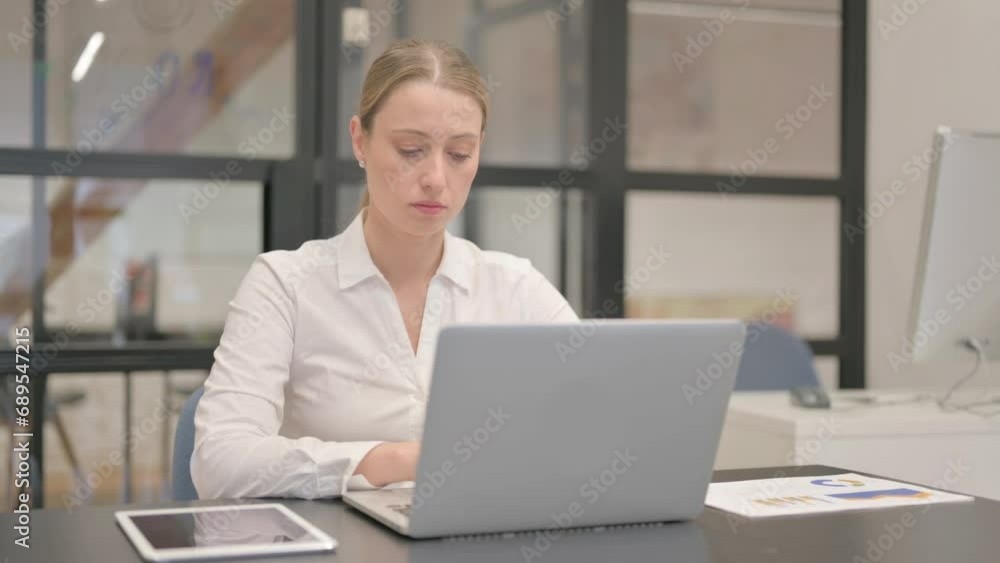 Mature Business Woman Typing on Laptop in Office Mature Business Woman Typing on Laptop in Office