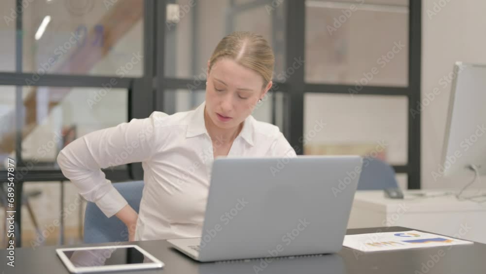 Mature Business Woman having Back Pain in Office Mature Business Woman having Back Pain in Office