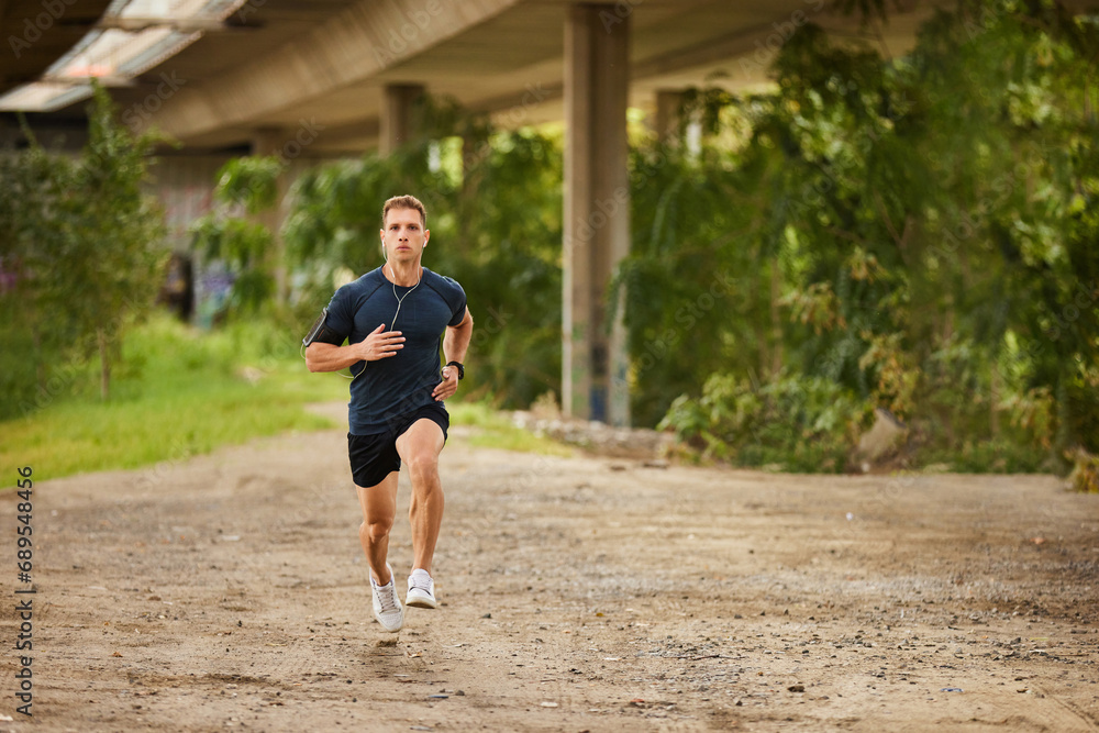 Young man running outdoors under the bridge Young man running outdoors under the bridge