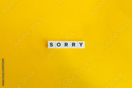 Sorry Word on Block Letter Tiles on Yellow Background. Minimalist Aesthetics. photo