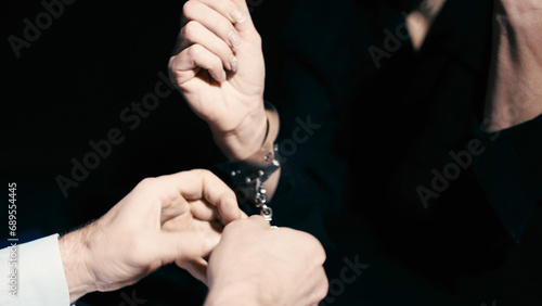 Принти на полотні A policeman is removing handcuffs from a woman in custody, indicating charges dr