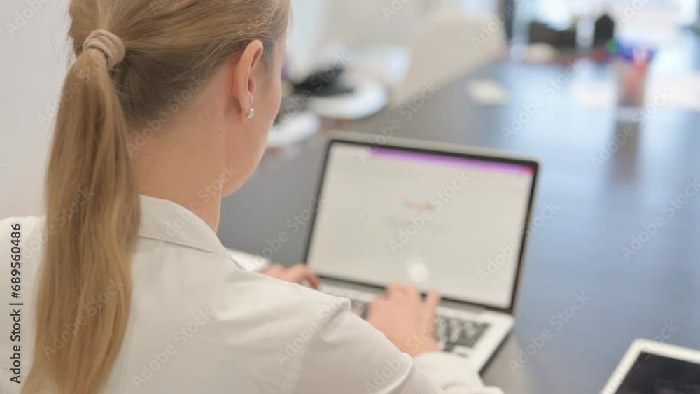 Business Woman Typing on Laptop, Rear view