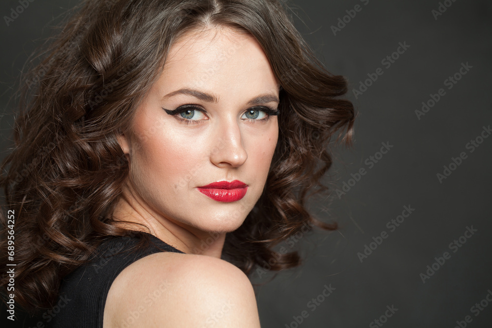 Pretty woman brunette with makeup and shiny wavy brown hair studio portrait. Fashion, make-up, hairstyle, personal care, beauty salon, cosmetics and fashion concept Pretty woman brunette with makeup and shiny wavy brown hair studio portrait. Fashion, make-up, hairstyle, personal care, beauty salon, cosmetics and fashion concept