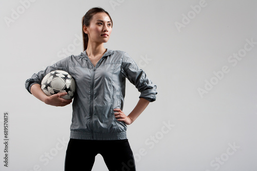 Determined Woman Carrying a Soccer Ball