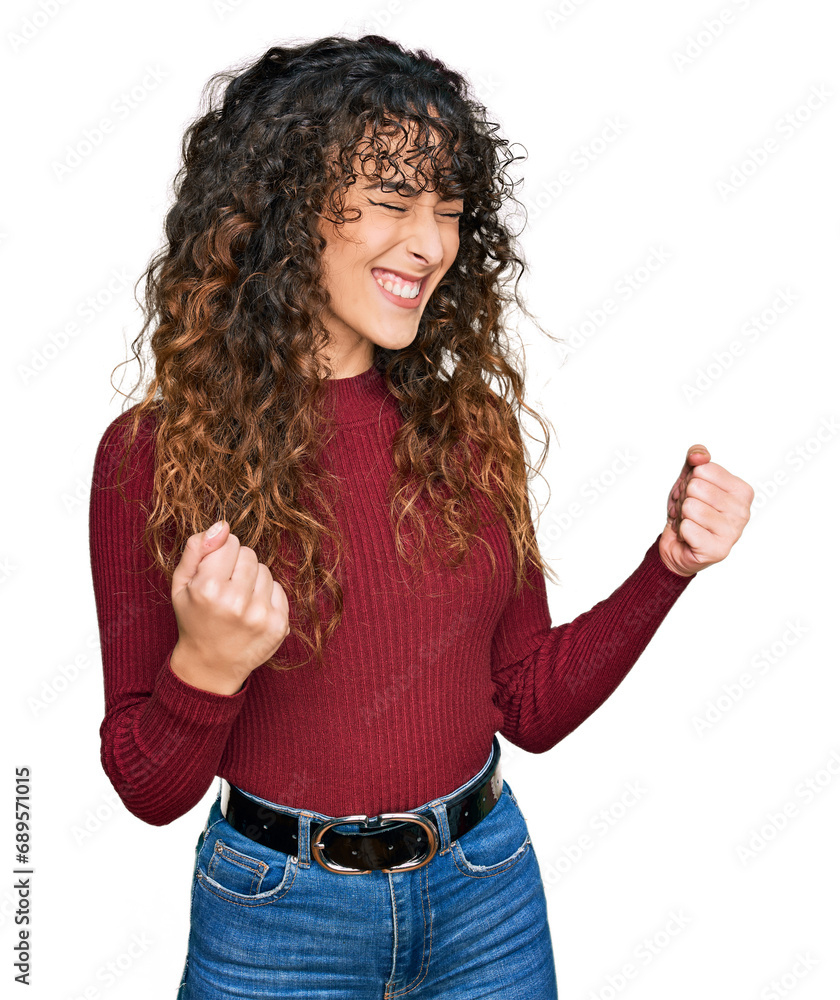 Young hispanic girl wearing casual clothes excited for success with arms raised and eyes closed celebrating victory smiling. winner concept. Young hispanic girl wearing casual clothes excited for success with arms raised and eyes closed celebrating victory smiling. winner concept.