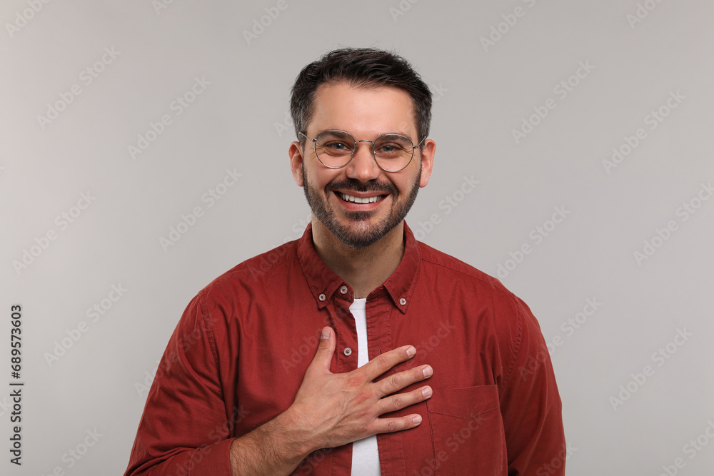 Portrait of happy man in stylish glasses on light grey background Portrait of happy man in stylish glasses on light grey background