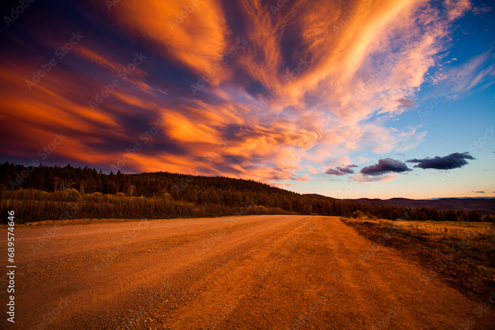 Burning clouds and dirt road in Aershan,China Burning clouds and dirt road in Aershan,China