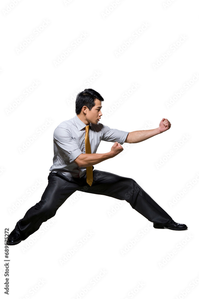 Businessman in martial arts fighting stance Businessman in martial arts fighting stance