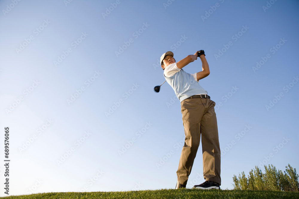 Golfer teeing off on the course