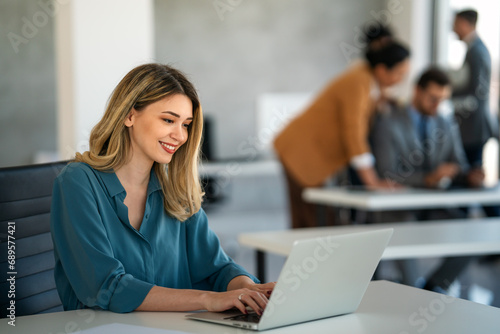 Successful businesswoman using laptop, working in office. Business technology corporate concept photo