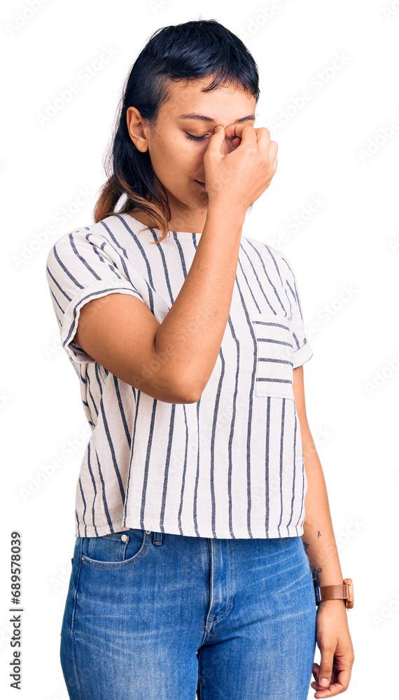 Young woman wearing casual clothes tired rubbing nose and eyes feeling fatigue and headache. stress and frustration concept. Young woman wearing casual clothes tired rubbing nose and eyes feeling fatigue and headache. stress and frustration concept.