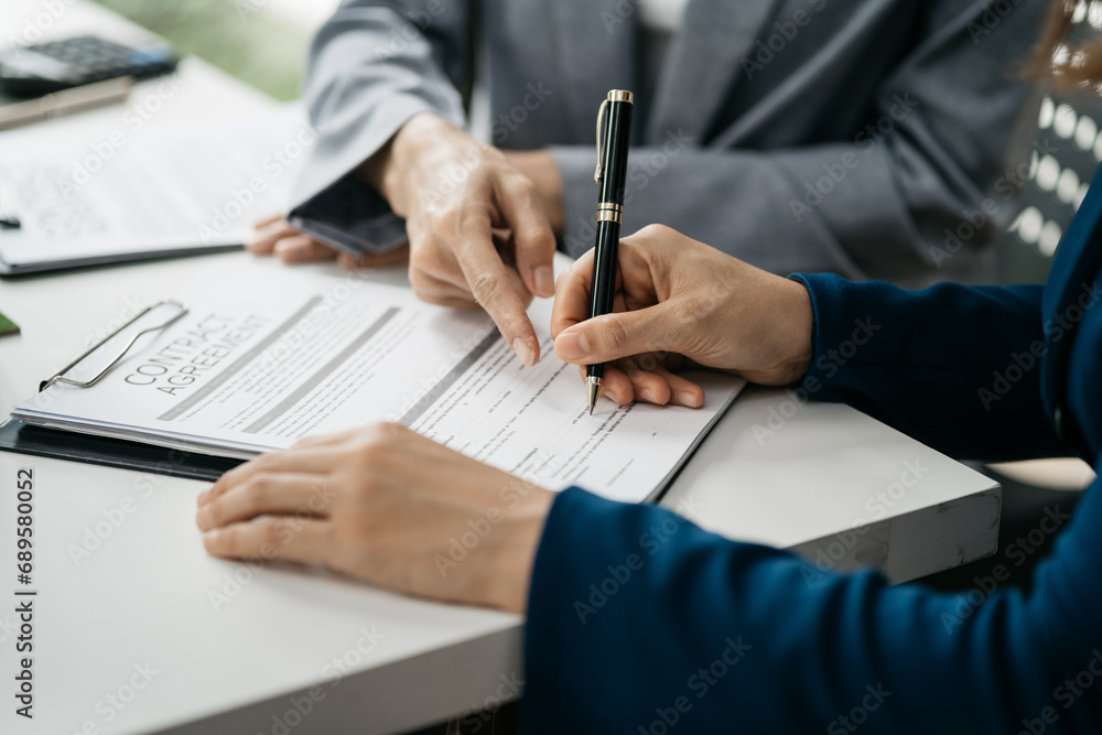 Real estate broker agent presenting and consult to customer to decision making sign insurance form agreement, home model, concerning mortgage loan offer in office. Real estate broker agent presenting and consult to customer to decision making sign insurance form agreement, home model, concerning mortgage loan offer in office.