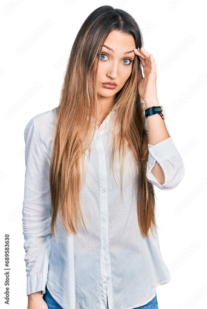Beautiful caucasian woman wearing casual white shirt worried and stressed about a problem with hand on forehead, nervous and anxious for crisis Beautiful caucasian woman wearing casual white shirt worried and stressed about a problem with hand on forehead, nervous and anxious for crisis