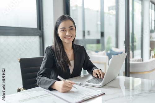Beautiful confident asian business woman working with laptop Hands typing keyboard. Professional investor working new start up project. business planning in office. Technology business