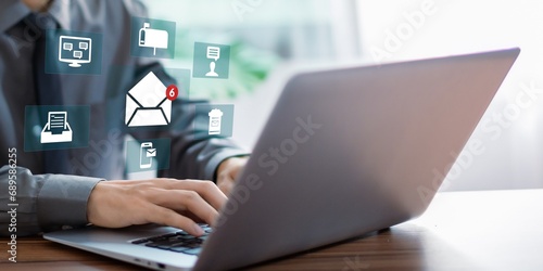 A person using laptop with email marketing concept, company sending many e-mails or digital newsletter to customers.