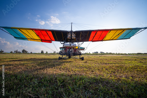 glider airplane. Small aviation sport. The motorized hang glider parked at the airfield at picturesque sunset