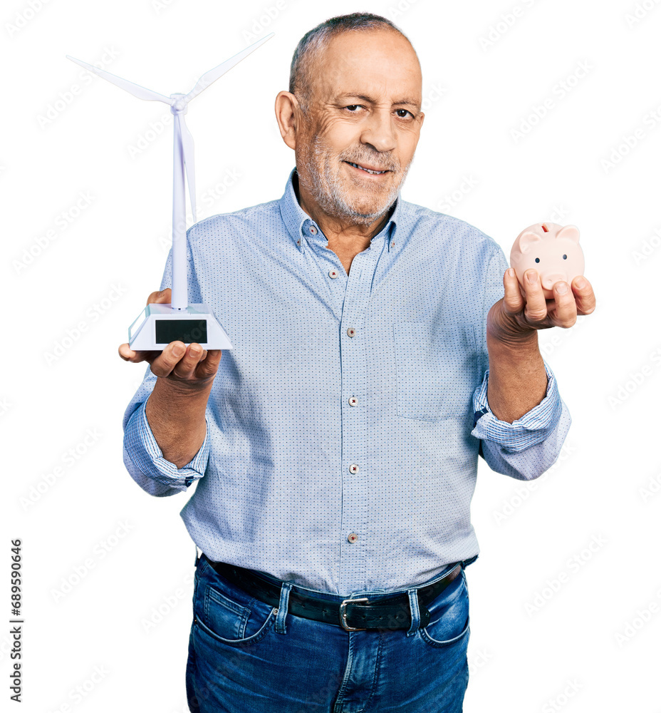 Φωτογραφία Senior man with grey hair and beard holding wind turbine and piggy bank smiling with a happy and cool smile on face