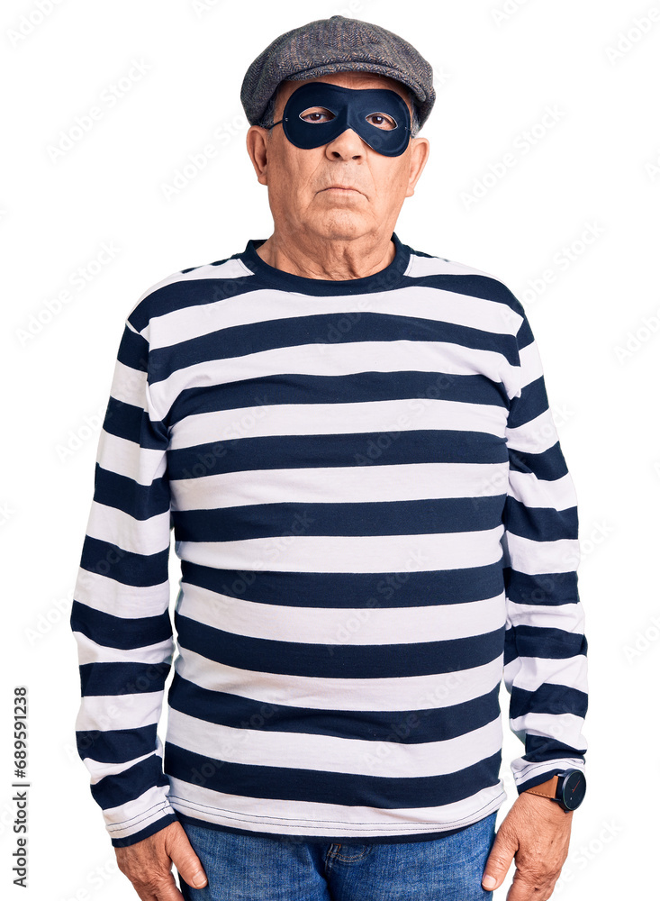 Senior handsome man wearing burglar mask and t-shirt looking sleepy and tired, exhausted for fatigue and hangover, lazy eyes in the morning.