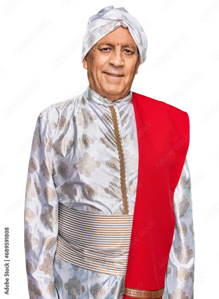 Senior hispanic man wearing tradition sherwani saree clothes relaxed with serious expression on face. simple and natural looking at the camera. Senior hispanic man wearing tradition sherwani saree clothes relaxed with serious expression on face. simple and natural looking at the camera.