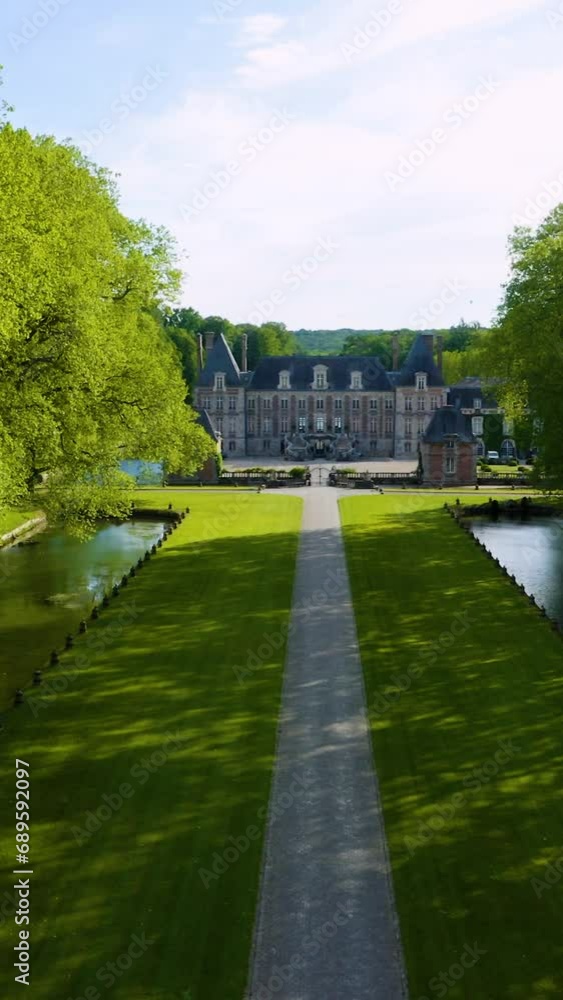 Beautiful medieval castle. Aerial View Shot of Castle. Château de Courances (Domaine de Courances). French castle. drone aerial view with landscaped gardens. Aerial vertical, vertical video background Beautiful medieval castle. Aerial View Shot of Castle. Château de Courances (Domaine de Courances). French castle. drone aerial view with landscaped gardens. Aerial vertical, vertical video background