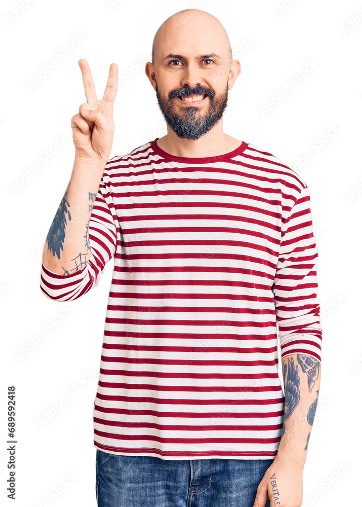 Young handsome man wearing casual clothes showing and pointing up with fingers number two while smiling confident and happy. Young handsome man wearing casual clothes showing and pointing up with fingers number two while smiling confident and happy.