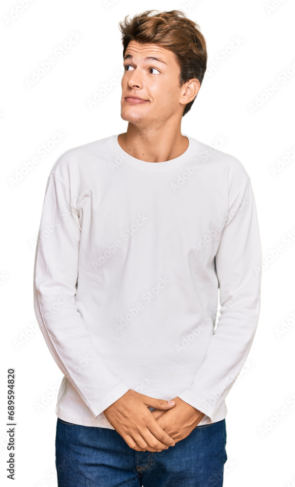 Handsome caucasian man wearing casual white sweater smiling looking to the side and staring away thinking. Handsome caucasian man wearing casual white sweater smiling looking to the side and staring away thinking.