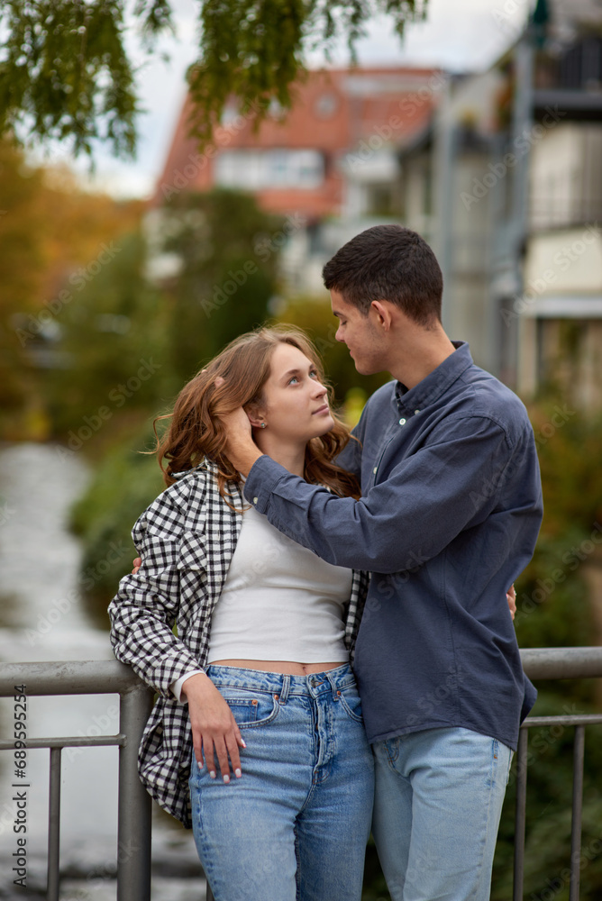 Fototapeta premium Warm Embrace of Teen Love in the Autumn Park. Capturing Teen Moments: Love Blossoms in Autumn's Embrace. Teenagers in Love: Embracing the Autumn Vibe