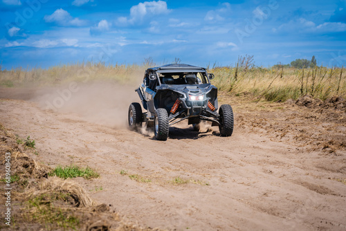 UTV buggy and 4x4 off road vehicle in sandy track. Buggy extreme riding
