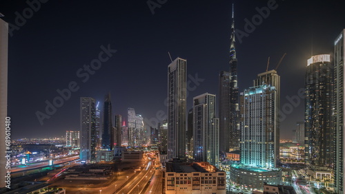 Photography Aerial view of Dubai Downtown skyline with many towers night timelapse