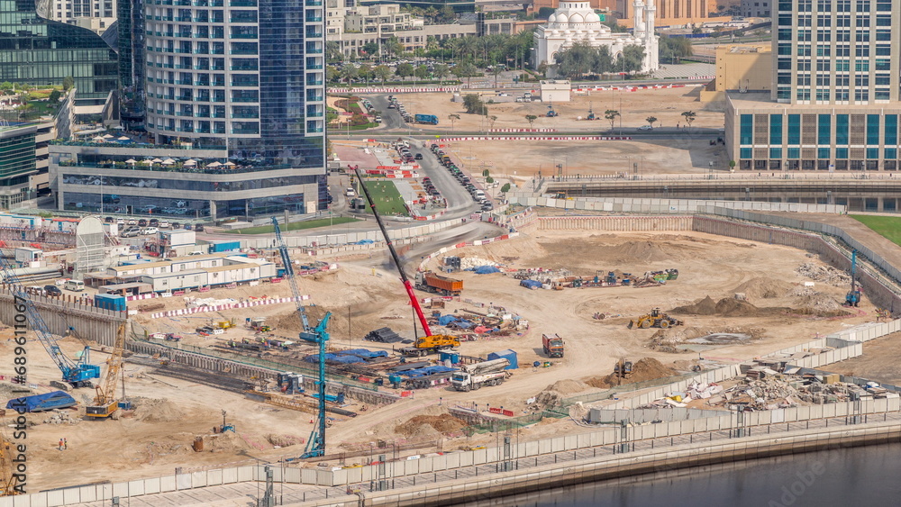 Pile driving in foundation pit for construction of apartment complex building aerial timelapse in UAE