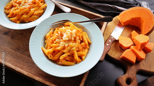 Healthy whole grain Penne, tube shaped pasta with pumpkin, goat cheese photo