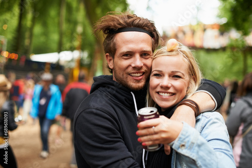 Happy couple, portrait and outdoor festival for love, care or support at party, DJ event or music. Man and woman hug with smile in embrace, affection or trust for festive or summer celebration photo