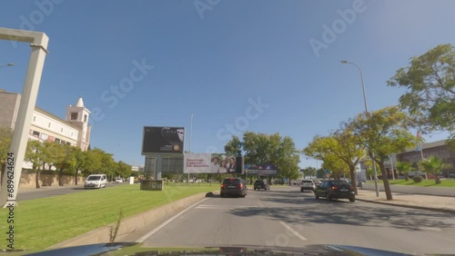First person view, FPV, from dashcam of car driving along the Algarve Coast in Portugal in Faro, driving on the highway. Road trip video in POV, with blue sky