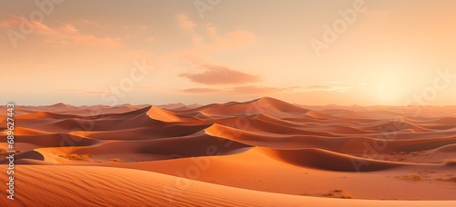 A sunset with sand dunes and clouds in the background