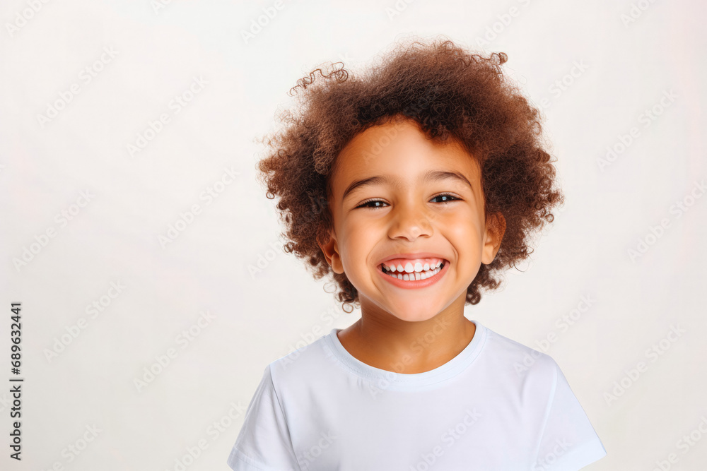 Cute mixed race boy child model with perfect clean teeth laughing and smiling, happy. Curly hair and white shirt, healthy. Isolated on white background. Cute mixed race boy child model with perfect clean teeth laughing and smiling, happy. Curly hair and white shirt, healthy. Isolated on white background.