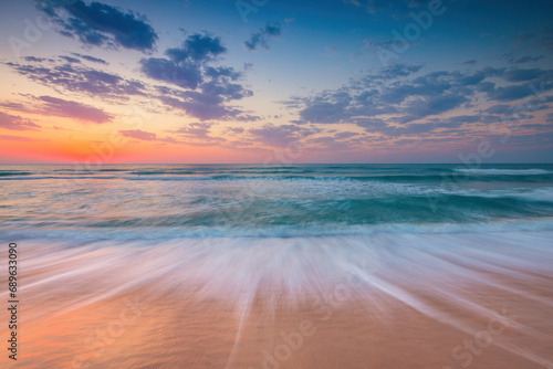 Beautiful sunrise over the sea and tropical sandy beach 