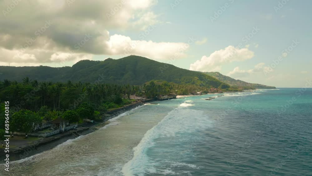 Aerial view on tropic island with turquoise ocean with pal trees at cloudy weather on Candidasa, Bali, Indonesia. Aerial view on tropic island with turquoise ocean with pal trees at cloudy weather on Candidasa, Bali, Indonesia.