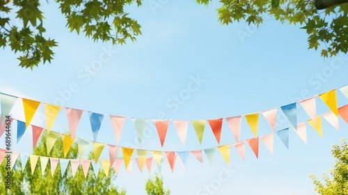 Colorful pennant string decoration in green tree foliage