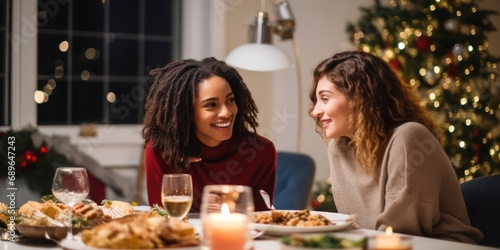 Happy american woman and diverse friend in a christmas dinner in a modern home