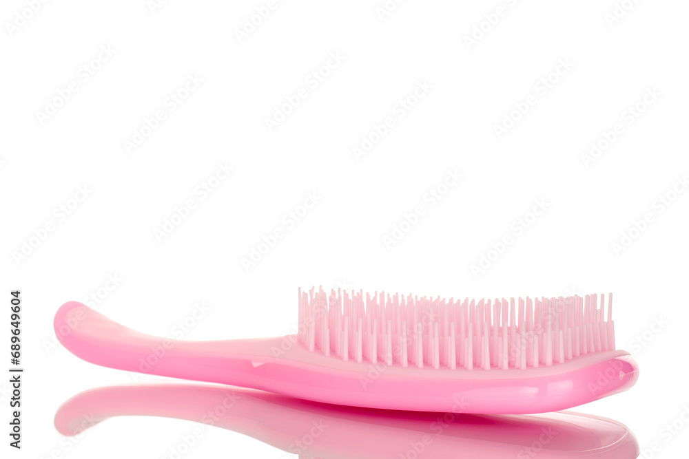 One pink plastic hair brush, macro, isolated on white background. One pink plastic hair brush, macro, isolated on white background.