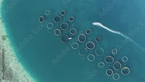 Aerial view of a boat sailing near the fish farm off the coastline in the ocean sea water, Grand Sable, Flacq District, Mauritius. photo