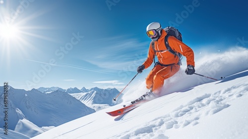 Freeride skiing. Skier on snowy slope against blue sky on sunny winter day. Banner with copy space. Skier skiing downhill in high mountains. © radekcho