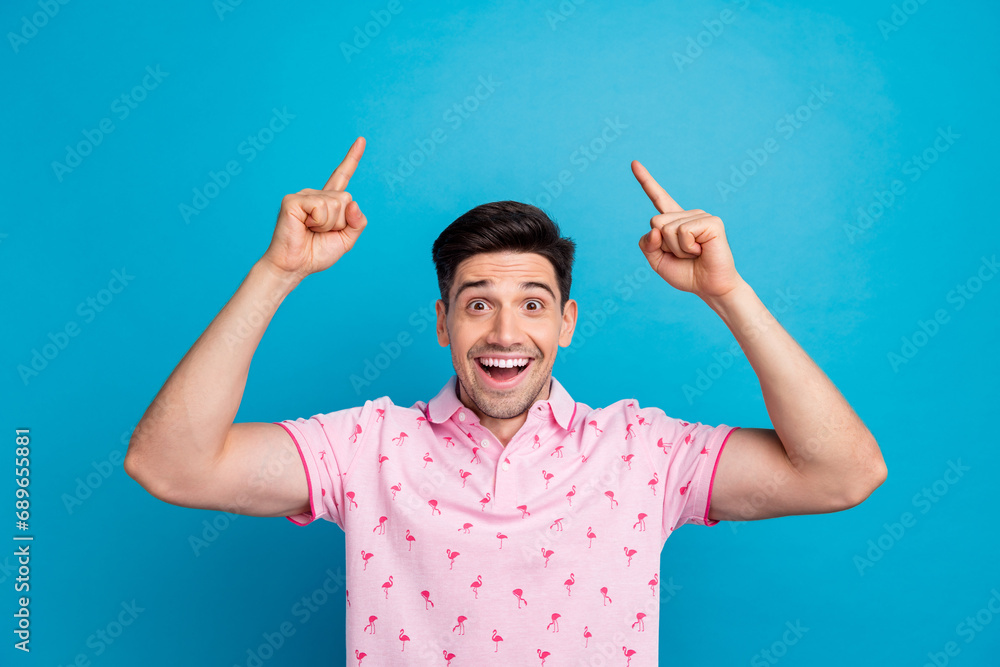 Photo of astonished nice person open mouth indicate fingers up empty space ad isolated on blue color background Photo of astonished nice person open mouth indicate fingers up empty space ad isolated on blue color background